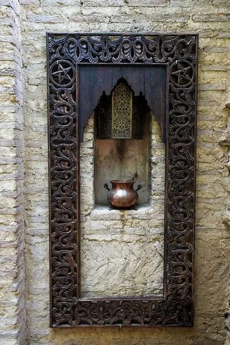 Framed Print : Fes, Morocco. Old copper pot sits on a ledge with a carved wooden frame Framed Print : Fes, Morocco. Old copper pot sits on a ledge with a carved wooden frame