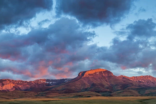 Fiery sunrise light strikes Ear Mountain along the Rocky Mountain Front near Choteau