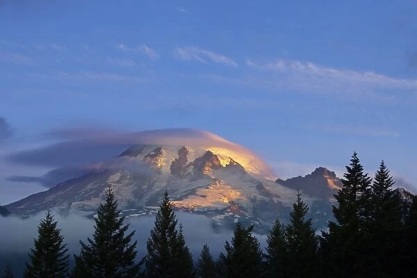 First light of the day strikes the slopes of Mount Rainier in Mount Rainier National