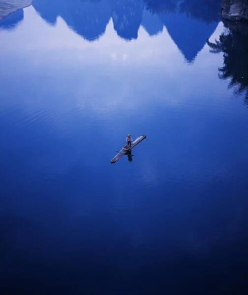 Fisherman on bamboo raft on Li River, Yangshuo, Guangxi Province, China