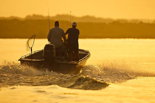 Fishermen boating toward the Laguna Madre, Texas, sunrise