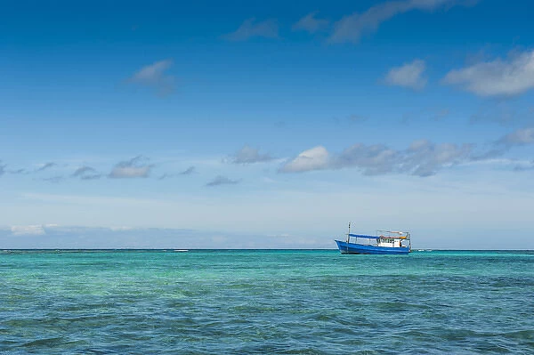 Fishing boat in the turquoise waters of the blue lagoon, Yasawas, Fiji, South Pacific
