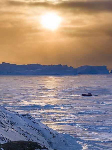 Fishing boats. Winter at the Ilulissat Fjord, located in the Disko Bay in West Greenland
