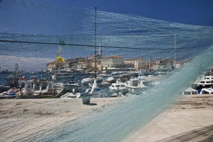 Framed Print : Fishing nets and harbor in front of distant Cathedral of St. Euphemia, Rovigno, Croatia Framed Print : Fishing nets and harbor in front of distant Cathedral of St. Euphemia, Rovigno, Croatia