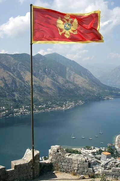 Flag of the Republic of Montenegro with the fjord at the background. Kotor