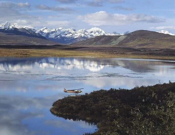 Float Plane on Lake, Denali Highway, Alaska Mountain range in background, Alaska