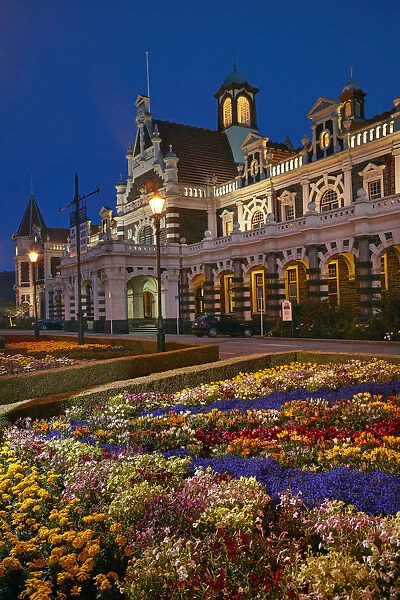 Flower garden and historic Railway Station at night, Dunedin, South Island, New Zealand