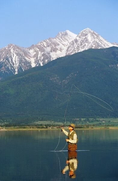 Fly fishing at Ninepipes Reservoir NWR with Mission Mountains in background in Montana