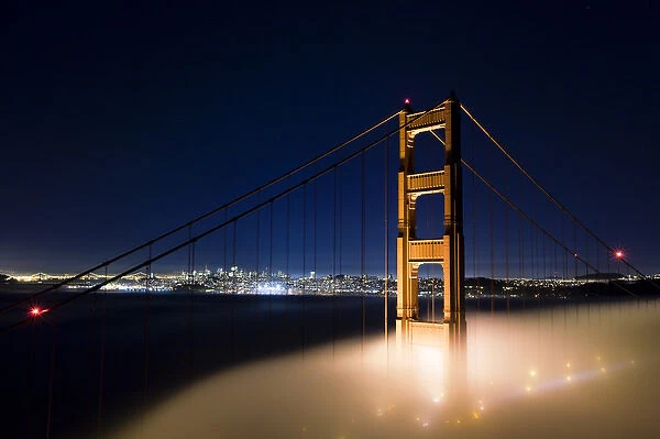 A foggy view of the Golden Gate Bridge and San Francisco with a clear sky above