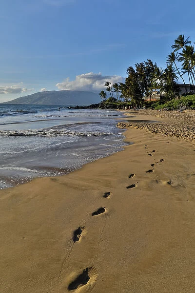 Footprints in the sand evening light along Kamaole Beach Park II, Kihei Maui, Hawaii