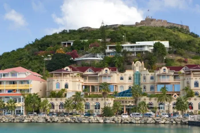 Framed Print : Fort St. Louis sits atop a hill above a modern day luxury shopping mall in Marigot, St