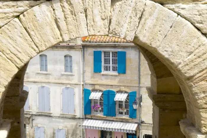 Framed Print : France, Arles, Roman Amphitheater arch and typical French window scene