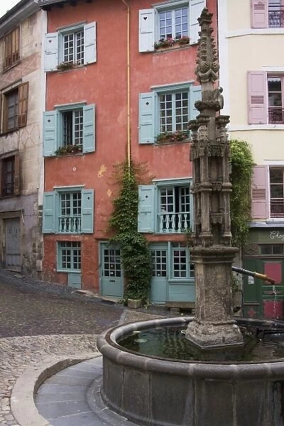 France, Auvergne Region, Haute-Loire Department. A communal fountain  /  well in Le Puy-en-Velay