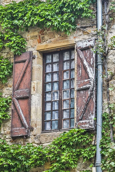 France, Cordes-sur-Ciel. Weathered shutters and window