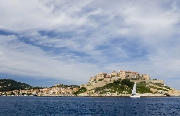 France, Corsica. Cirrus clouds above old city at Calvi within the walls of the historic
