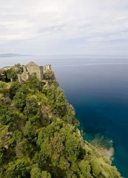 France, Corsica. Ruins of Genoese Tower above Mediterreanean Sea at village of Nonza
