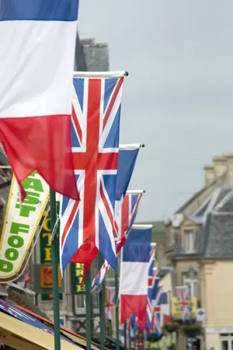 Framed Print : France, Normandy, Arromanches. Ceremonial flags line the streets of Normandy for