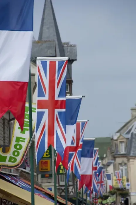 Framed Print : France, Normandy, Arromanches. Ceremonial flags line the streets of Normandy for