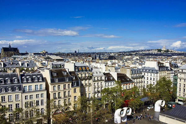 France, Paris. Houses facing Beaubourg, Centre Pompidou square, Eiffel tower on the far left