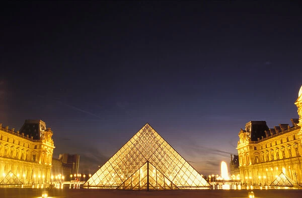 France, Paris, Louvre museum and Pei Pyramid at dusk