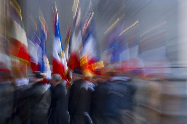 France, Paris. Military ceremony with flags at the Arc de Triomphe
