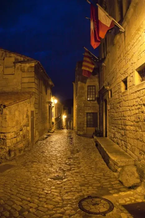 Framed Print : France, Provence, Les Baux-de-Provence. Flags over deserted street inside castle at night Framed Print : France, Provence, Les Baux-de-Provence. Flags over deserted street inside castle at night