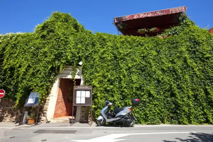 Framed Print : France, Provence, Roussillon. Motorcycle outside restaurant entrance. Credit as