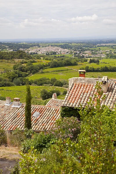 France, Provence, Seguret. View of countryside above tiled rooftops. Credit as: Fred