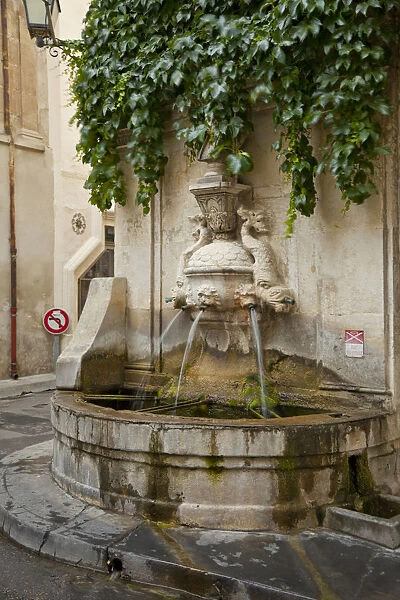 France, Provence, St. Remy-de-Provence. Water fountain on street corner. Credit as