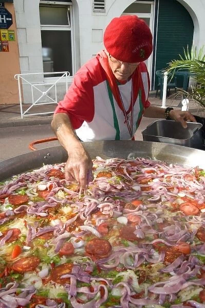 French Basque man cooking paella in the town of Biarritz, Pyrenees-Atlantiques, French