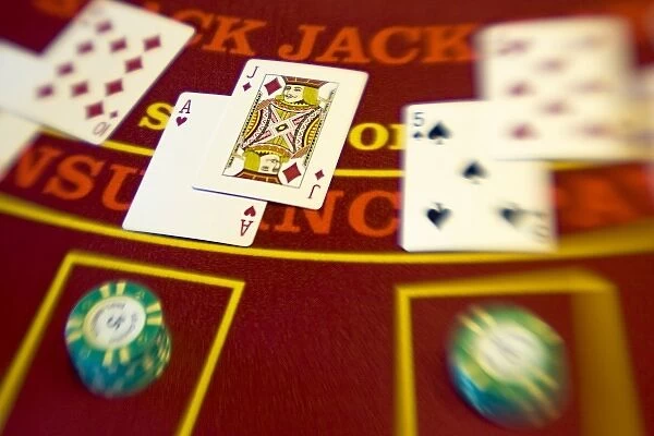 French Polynesia. Black jack hands and poker chips on a casino table aboard Paul Gaugin cruise ship