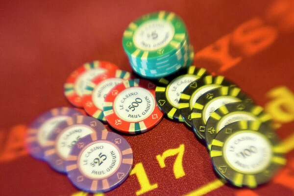 French Polynesia. Colorful poker chips on casino table aboard Paul Gaugin cruise ship