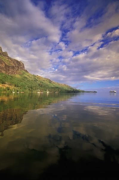 French Polynesia, Moorea. Cooks Bay. Cruise ship Paul Gaugin and bay reflection