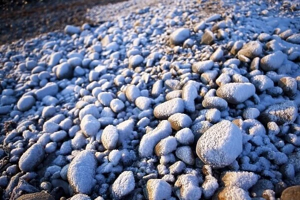 Fresh snow on cobble stones on the New Hampshire coast in Odiorne State Park in Rye, New Hampshire