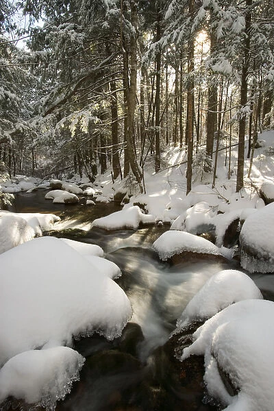 Fresh snow covers the rocks in Wonalancet Brook in New Hampshires White Mountain