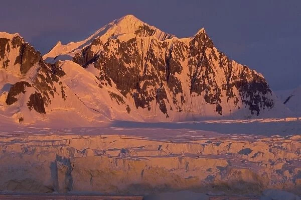 frozen glacial mountain landscape along the western Antarctic peninsula at sunset