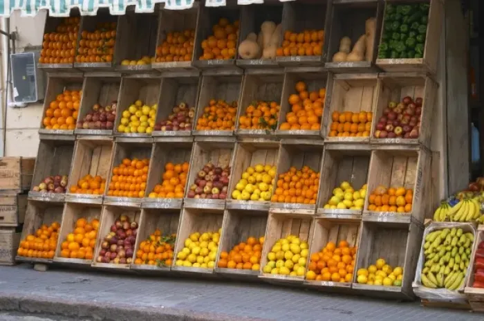 Framed Print : A fruit and vegetable shop displaying products in wooden crates on the street: tomatoes