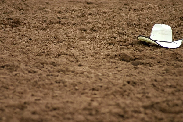 Galisteo, New Mexico, United States. Rodeo hat left in dirt at Galisteo Rodeo