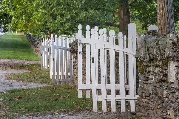 Gate and white wooden fence and rock wall, Shaker Village of Pleasant Hill, Harrodsburg, Kentucky
