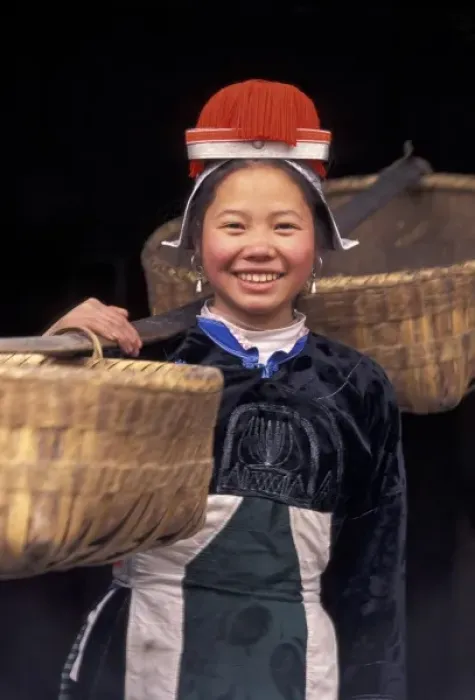 Framed Print : Gejia Miao girl carrying baskets in traditional costume, Matang, Guizhou Province, China Framed Print : Gejia Miao girl carrying baskets in traditional costume, Matang, Guizhou Province, China