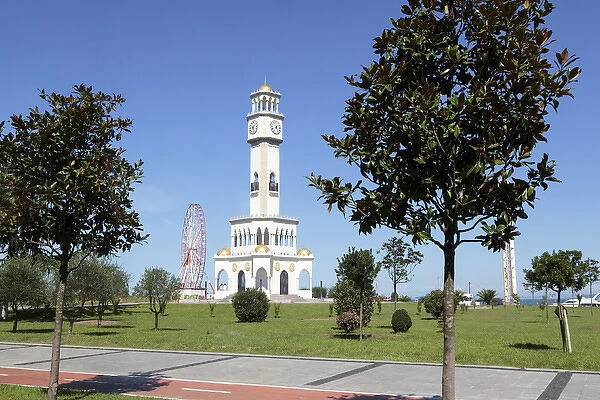 Georgia, Batumi. A clocktower and ferris wheel on the Black Sea coast in Batumi
