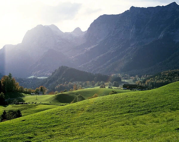 Germany, Bavaria, Berchtesgaden. Small farms sit at the foot of the Alps near Berchtesgaden