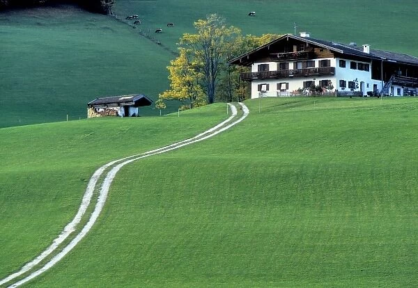 Germany, Bavaria, Berchtesgaden. A long road leads to an isolated farm house near Berchtesgaden