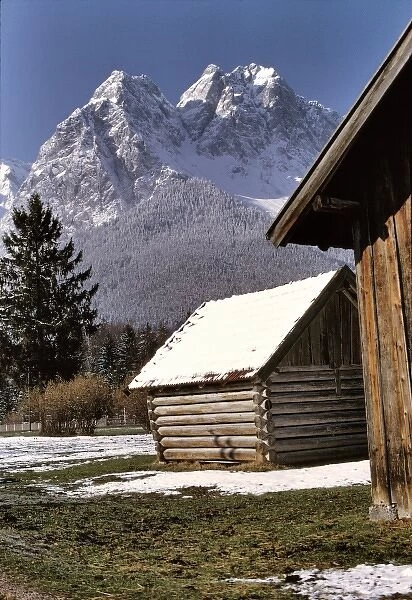Germany, Bavaria, Zugspitze. A light snow covers the roofs of hay barns near the