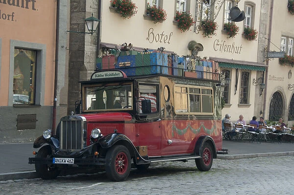 Germany, Franconia, Rothenburg. Old gift truck in front of the Kathe