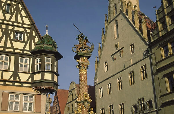 Germany, Rothenburg, Looking up at buildings and statue of St. George and the Dragon