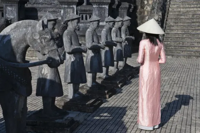 Framed Print : Girl in Ao Dai (traditional Vietnamese long dress) and conical hat at Tomb of King Framed Print : Girl in Ao Dai (traditional Vietnamese long dress) and conical hat at Tomb of King