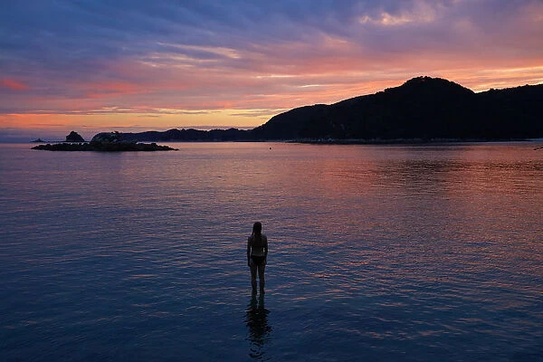 Girl in the water at dusk, Mosquito Bay, Abel Tasman National Park, Nelson Region
