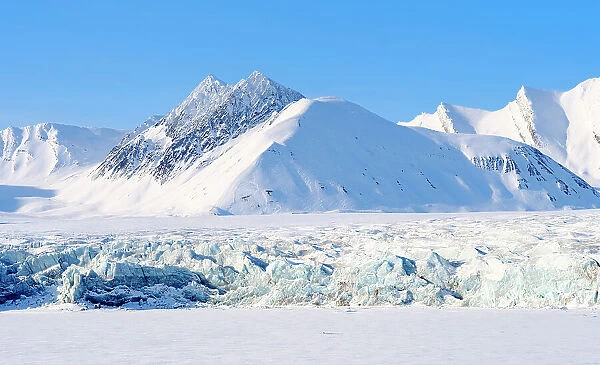 Glacier front of Fridtjovbreen and the frozen fjord Van Mijenfjorden. Landscape in Van Mijenfjorden National Park, (former Nordenskiold National Park), Island of Spitsbergen. Arctic region, Scandinavia, Norway, Svalbard