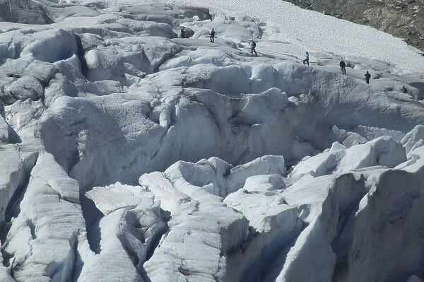 Glacier hikers wind through the blue ice crevices and over snow fields of Folgefonna Glacier